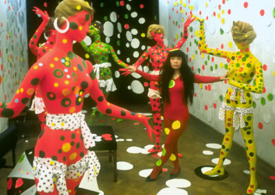 Kusama poses among dolls in Orez Gallery (1967)